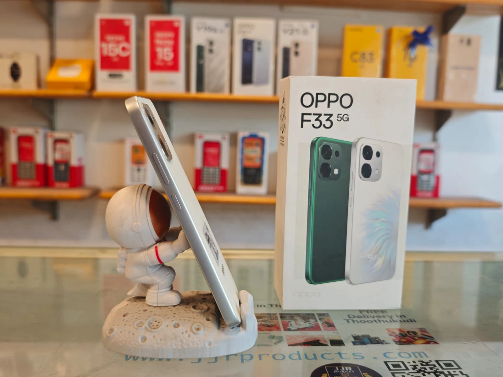 OPPO F33 5G Pearl White smartphone displayed with retail box, featuring 50MP AI dual rear camera, 16MP selfie camera, Dimensity 6360 MAX processor, and 7000mAh battery.