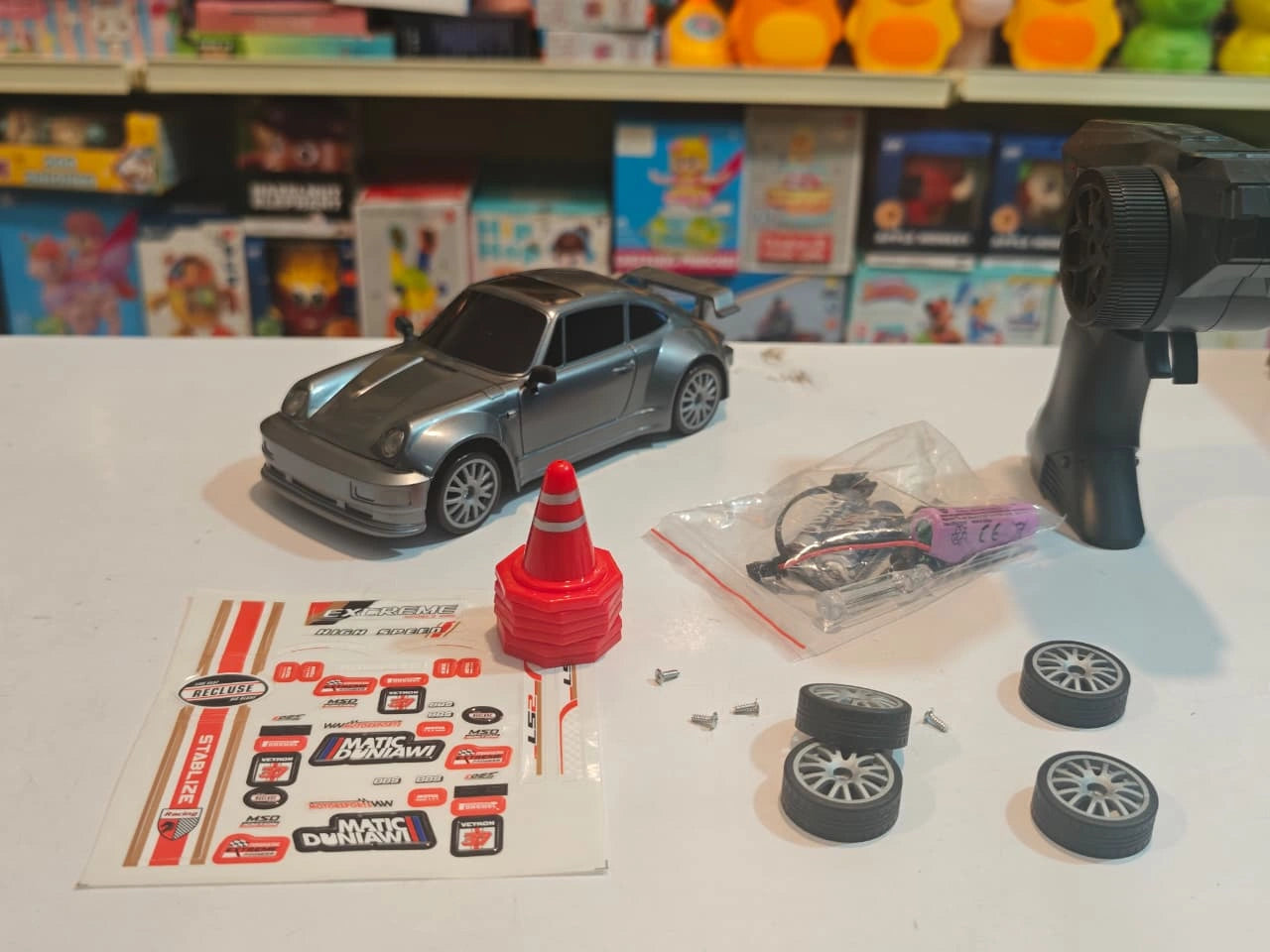 High-Speed Drift Racing RC Car with remote control, rechargeable battery, extra drift wheels, traffic cones and racing stickers available at Toy Trendz by JJR Mart Thoothukudi.