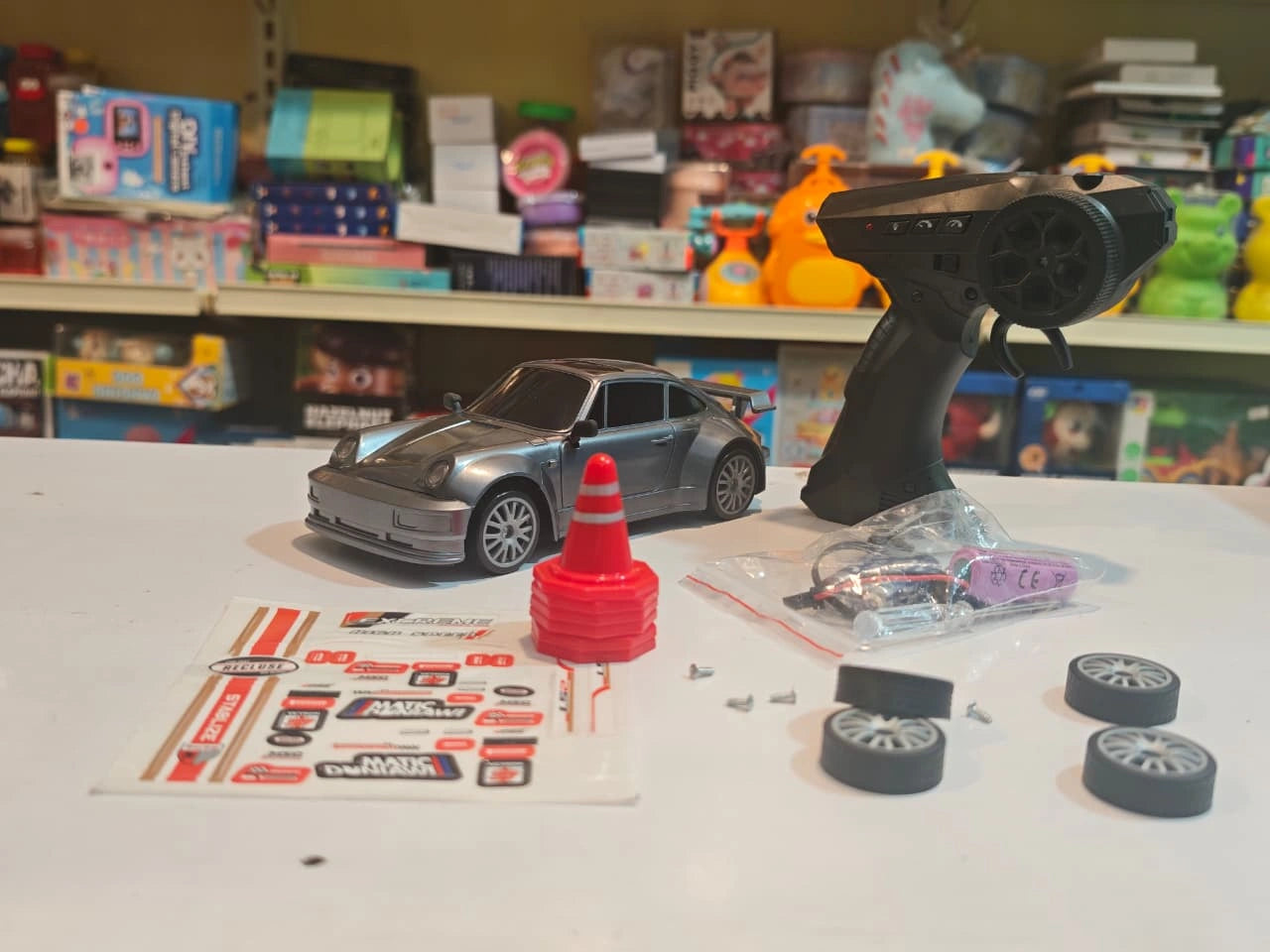 High-Speed Drift Racing RC Car with remote control, rechargeable battery, extra drift wheels, traffic cones and racing stickers available at Toy Trendz by JJR Mart Thoothukudi.