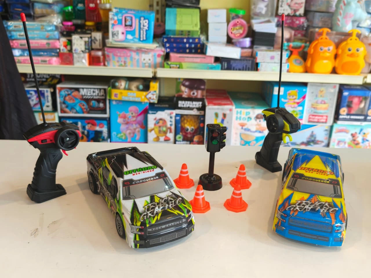ToyBoi RC Racing Pickup Truck Set featuring two off-road racing trucks, traffic cones, signal light accessories, LED lights and remote control action available at Toy Trendz by JJR Mart Thoothukudi.