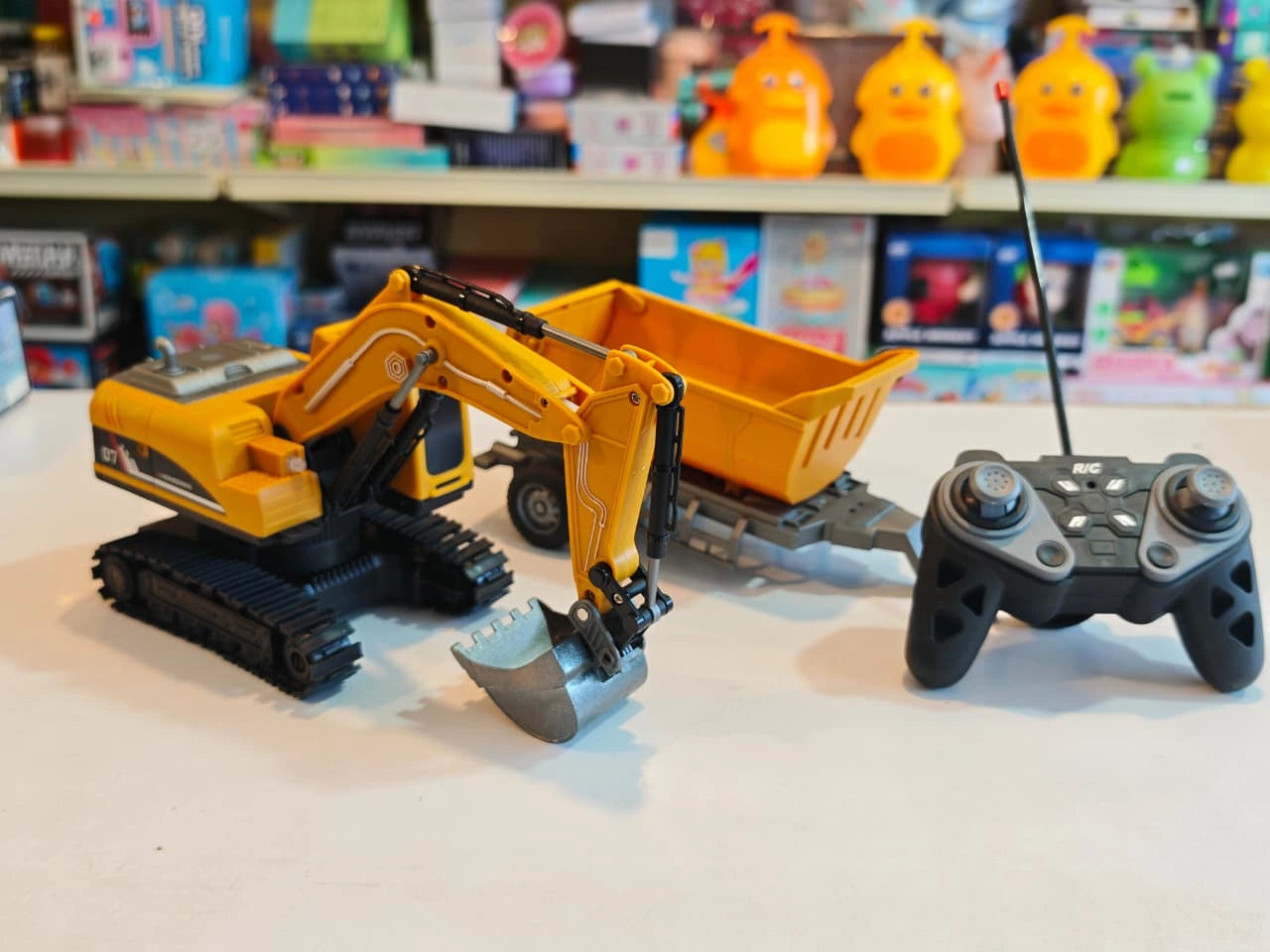 Remote Control Engineering Excavator with tracked wheels, movable digging arm, detachable dump trailer and wireless controller available at Toy Trendz by JJR Mart Thoothukudi.