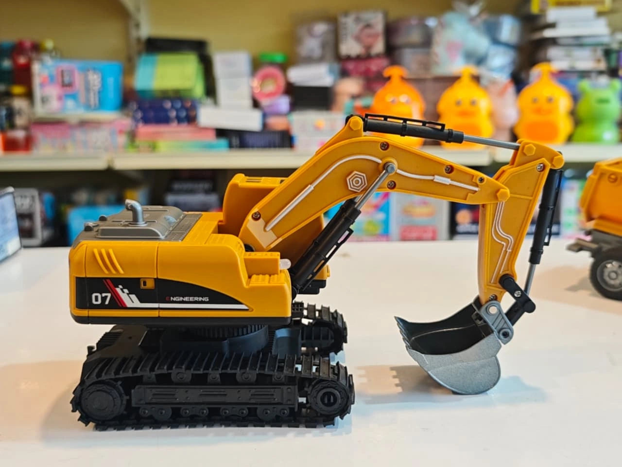 Remote Control Engineering Excavator with tracked wheels, movable digging arm, detachable dump trailer and wireless controller available at Toy Trendz by JJR Mart Thoothukudi.