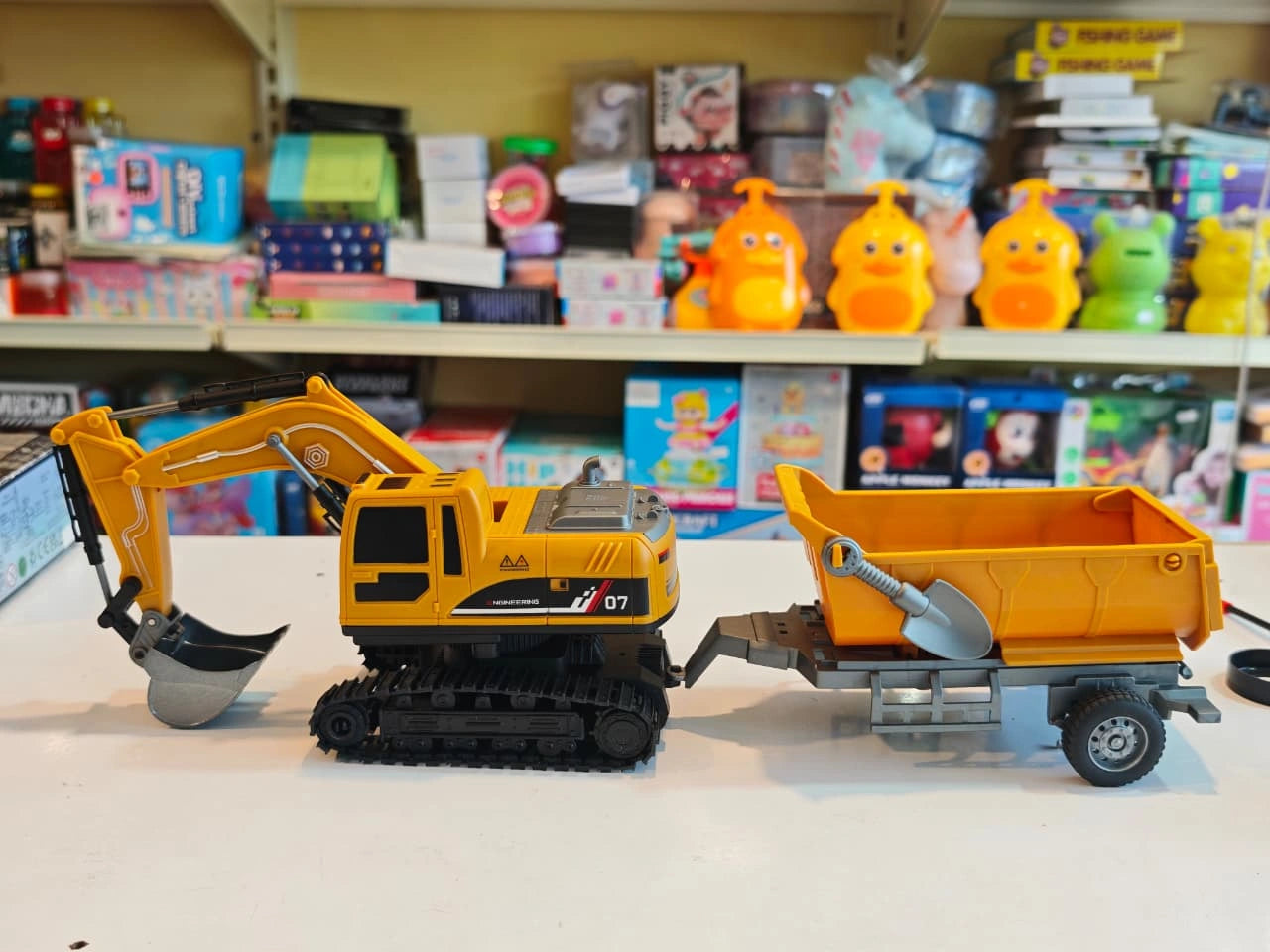 Remote Control Engineering Excavator with tracked wheels, movable digging arm, detachable dump trailer and wireless controller available at Toy Trendz by JJR Mart Thoothukudi.