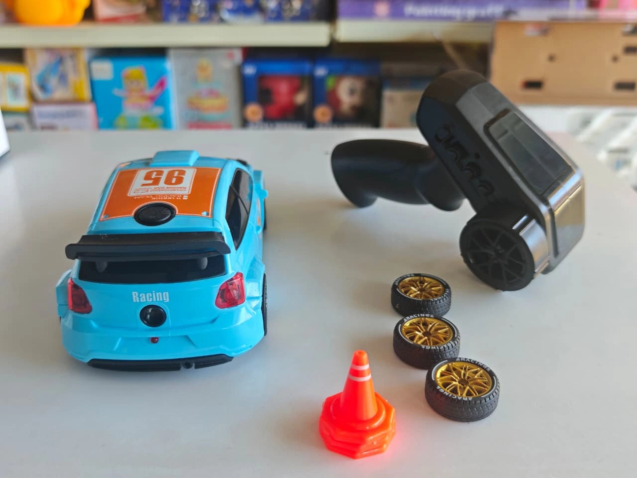 ToyBoi RC Rally Spray Drift Car 4WD with LED lights, drift wheels, spray effect, 2.4GHz controller and traffic cone accessories.