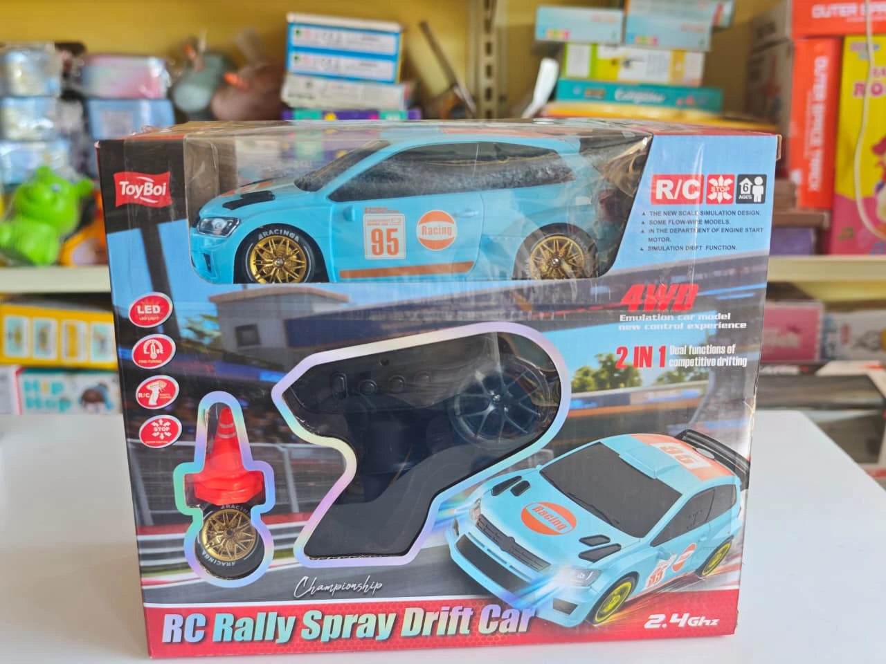 ToyBoi RC Rally Spray Drift Car 4WD with LED lights, drift wheels, spray effect, 2.4GHz controller and traffic cone accessories.